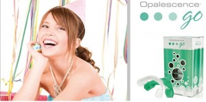 Woman smiling next to Opalescence Go kit